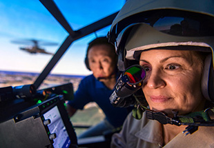 Picture of a man holding a tablet and a woman next to him pointing to tablet screen.