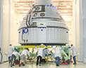 Picture of the CST-100 Starliner at the Commercial Crew and Cargo Processing Facility at Kennedy Space Center prior to the December 2019 Orbital Flight Test.