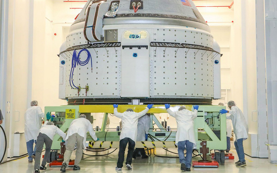 Picture of the CST-100 Starliner at the Commercial Crew and Cargo Processing Facility at Kennedy Space Center prior to the December 2019 Orbital Flight Test.
