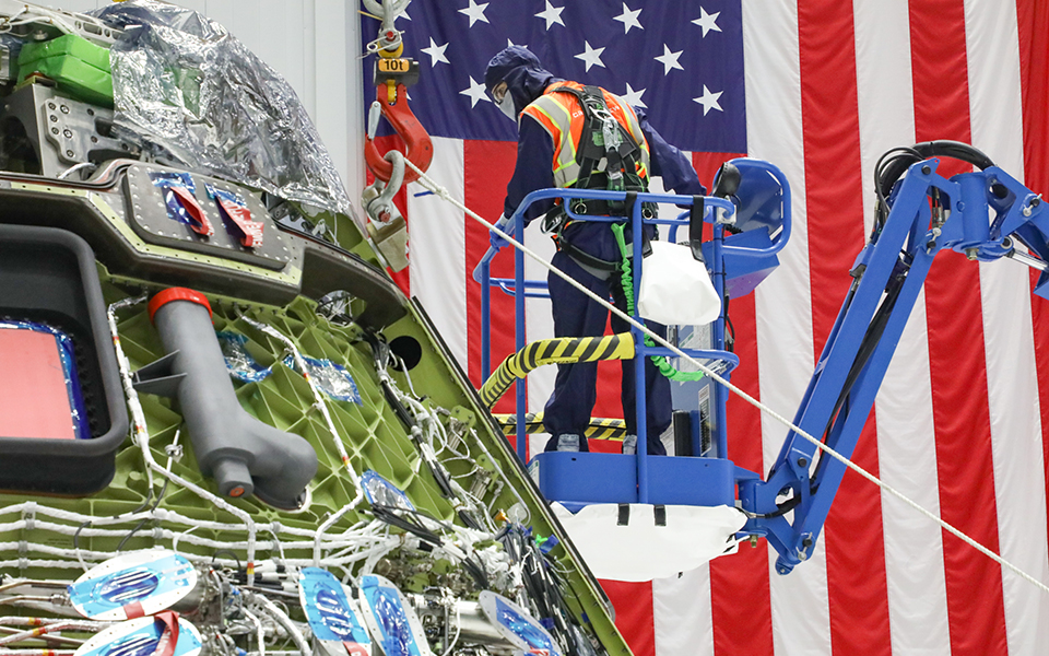 Picture of a technician working on the crew module.