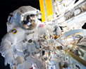Picture of astronaut outside space station.