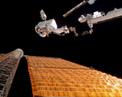 Picture of astronaut outside space station.