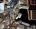 Picture of an astronaut working outside space station.