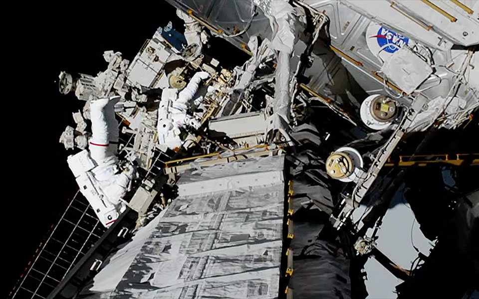 Picture of astronauts outside space station.