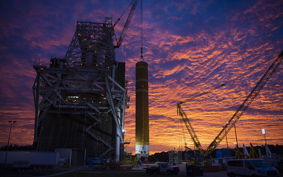Picture of the Boeing Space Launch System on launch pad sunrise.