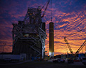Picture of the Boeing Space Launch System on launch pad sunrise.